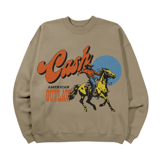Tan crewneck sweater featuring a cowboy graphic and "Cash" logo above the text "American Outlaw" in a western style font
