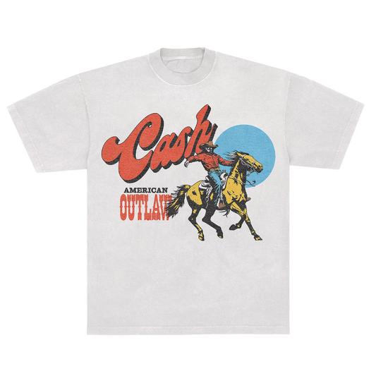 White unisex t-shirt featuring a cowboy graphic and "Cash" logo above the text "American Outlaw" in a western style font